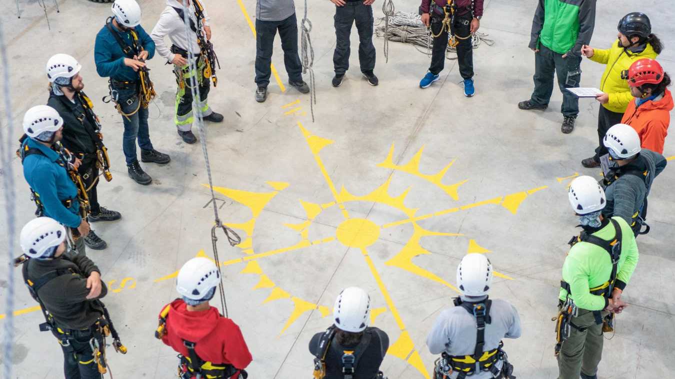 Workers wearing harnesses for specialized fall protection support