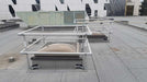 Rooftop metal railing is installed for height safety guards.