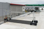 A ladder stabilizer is installed on the rooftop for safety at heights.