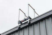 A ladder stabilizer is installed on the rooftop for fall safety