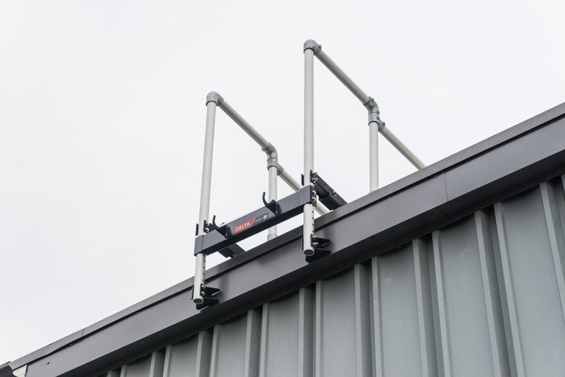 A ladder stabilizer is installed on the rooftop for fall safety