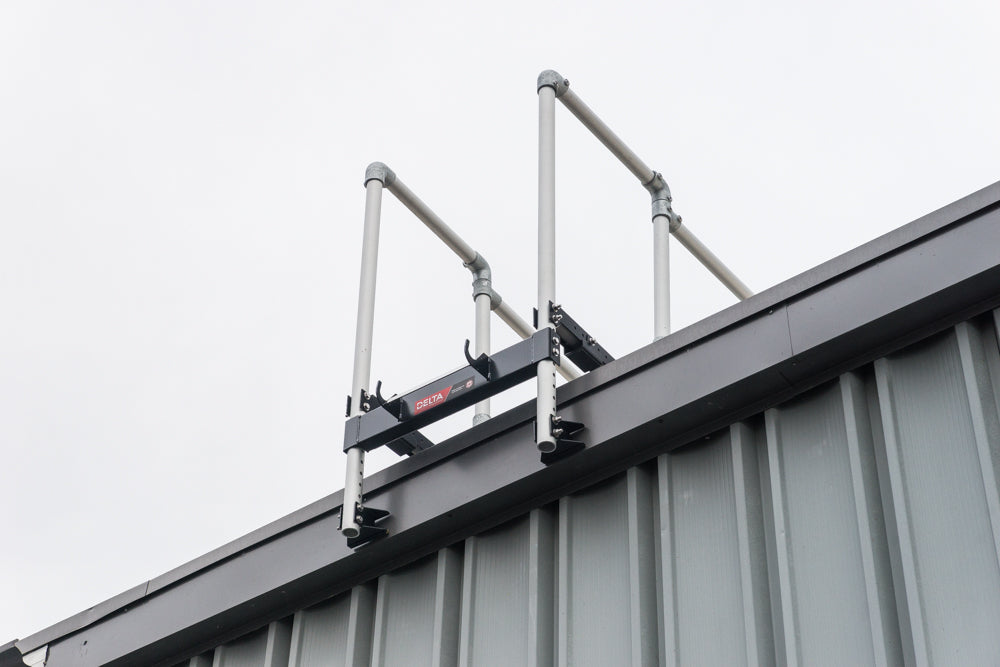 A ladder stabilizer is installed on the rooftop for fall safety