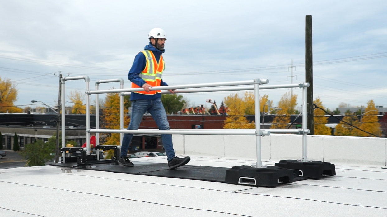 A ladder stabilizer is installed on the rooftop for height safety.