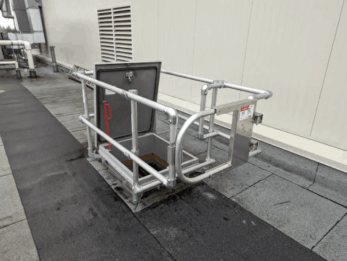 A metal railing with a safety for fall protection on a rooftop