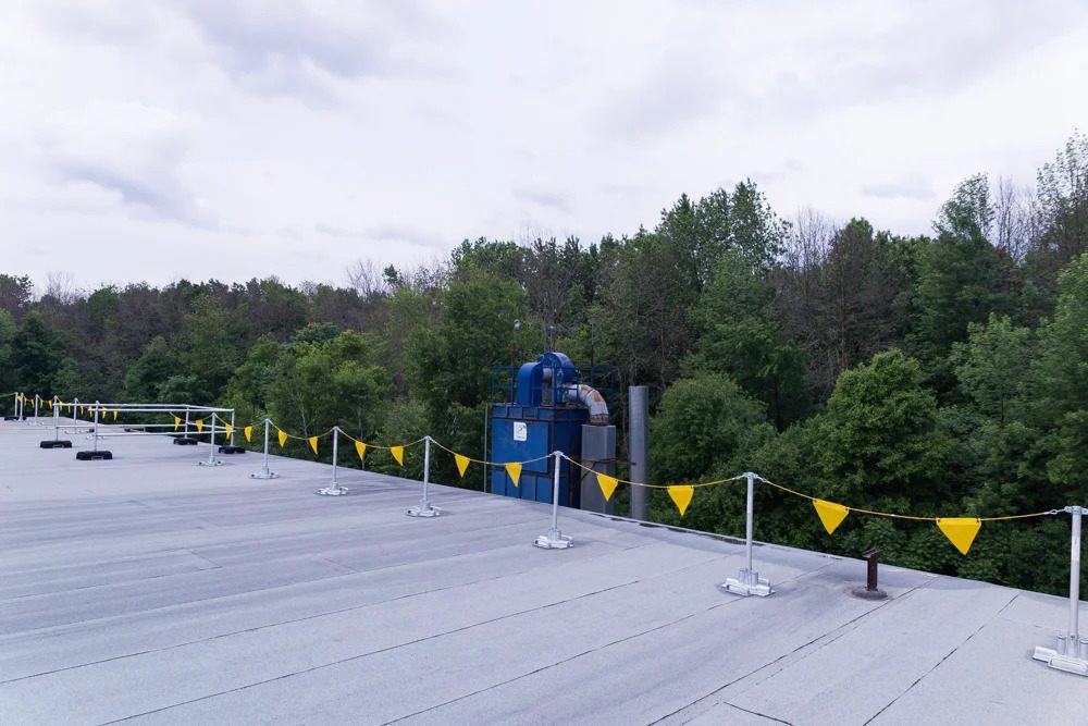 The rooftop is equipped with permanent yellow safety barriers.