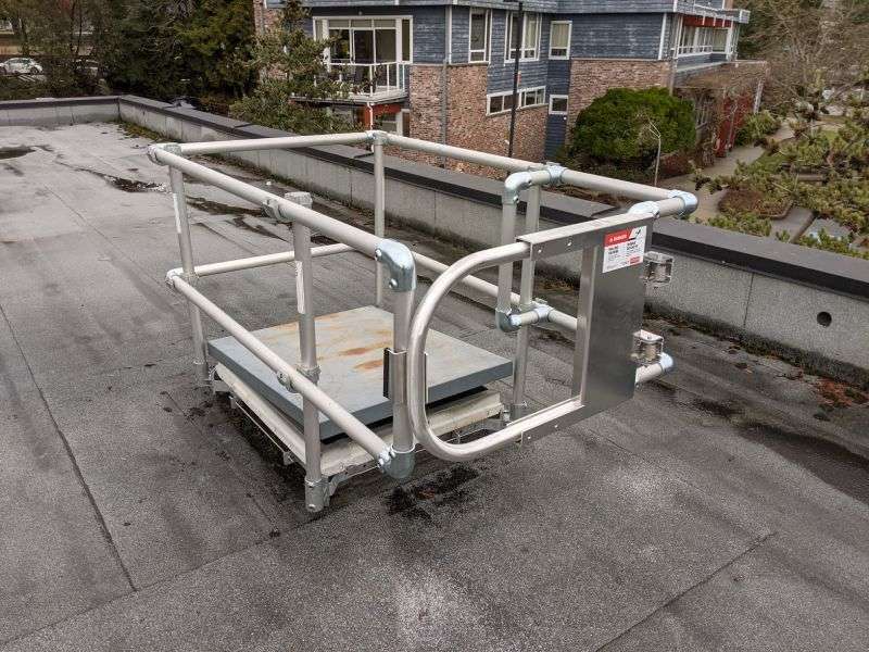 A metal railing with a safety for fall protection on a rooftop
