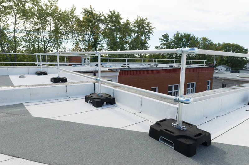 Rooftop with metal railing and equipment that is used for fall protection