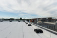 Rooftop view with a railing for fall protection safety